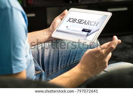 Happy job seeker trying to find work using online search engine home with tablet, Unemployment concept. Hopeful, motivated and excited man, fingers crossed. Jobseeker with positive attitude. Royalty-Free Stock Photo #797072641