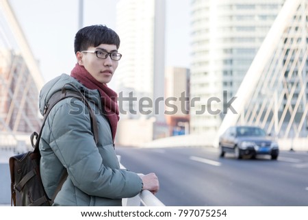 A portrait of a young asian man in the city
