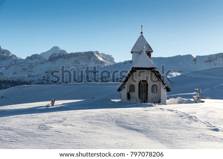 Sunny view of a little chapel near the ski piste in the Alta Badia ski area