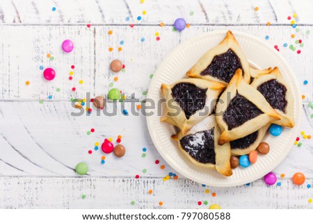 Traditional Jewish Hamantaschen cookies with berry jam. Purim celebration concept. Jewish carnival holiday background
