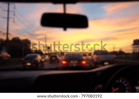 Blurred background of view from driving a car on the road at sunrise.