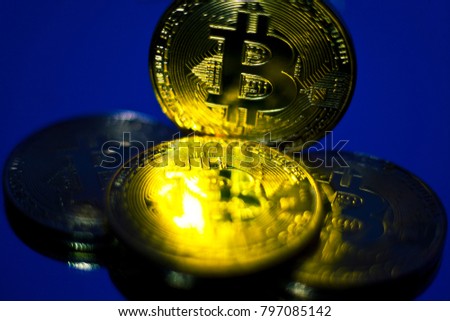 Bitcoin. several coins of bitcoin on a blue background, toned.