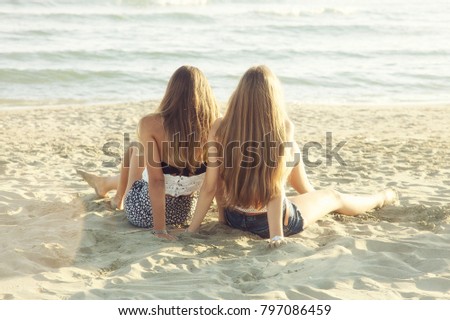 Happy girls in summer on beach