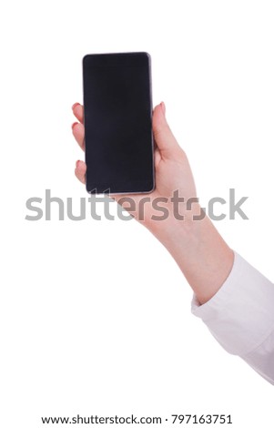 The hand of a girl is holding a smartphone. Isolated on white background. Close-up.
