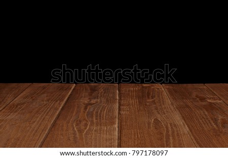 Empty wooden table isolated on black background including clipping path