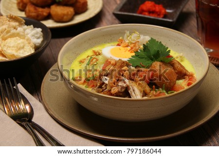 Soto Medan. Creamy coconut milk soup with fried chicken, glass noodles, bean sprouts, egg, and potato cake from Medan, North Sumatra. Royalty-Free Stock Photo #797186044