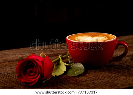 fresh cappuccino with red rose on wood table
