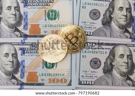 Gold coin of bitcoin on the background of dollars.
