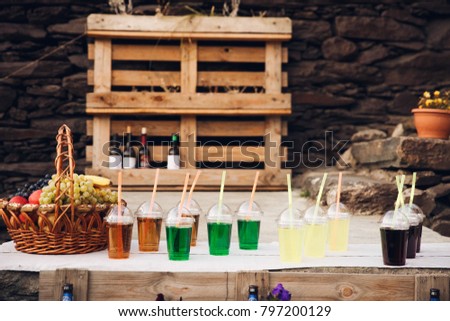 Colorful drinks stand on the table with fruits