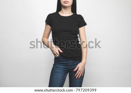 attractive young woman in blank black t-shirt on white