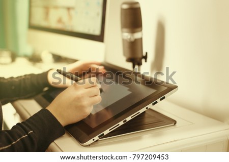 Drawing, photography and retouching on a computer laptop using a digital tablet and stylus pen.