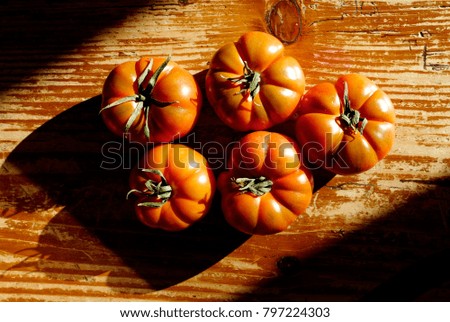 red italian tomatoes on a wooden kitchen table