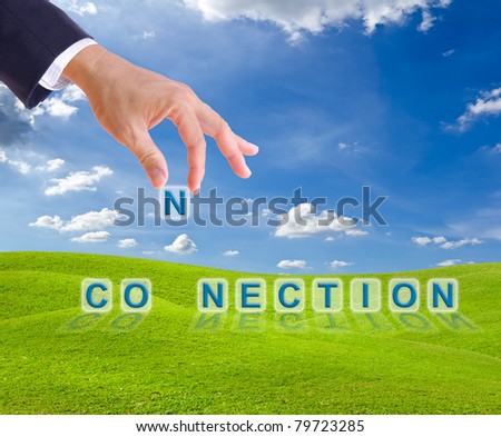 business man hand and connection word buttons on green grass meadow