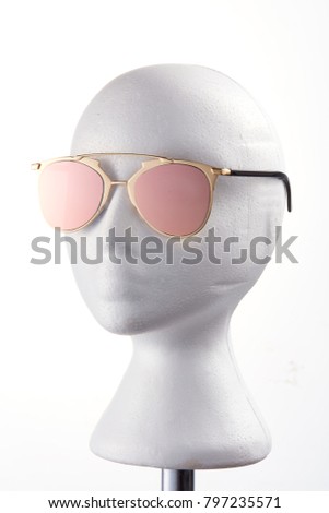Fashion design glasses wearing on a white mannequin against white background. 