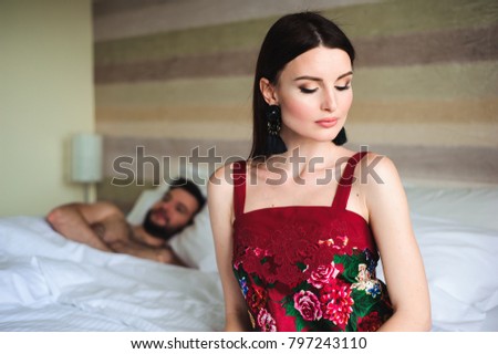 Couple in bed, portrait of a sad woman in bed with her husband