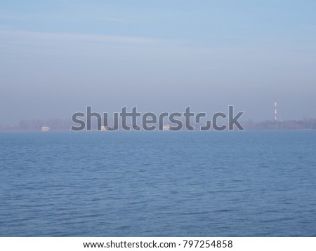 Lakeside landscape of artificial water Goczalkowice Reservoir in Poland with waterfront and clear blue sky in 2017 cold sunny winter day, Europe on December.