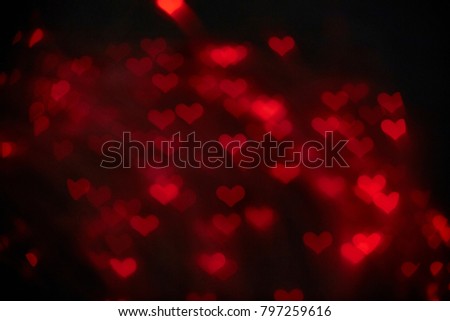 Color Bokeh on a dark background with hearts for use in graphic design