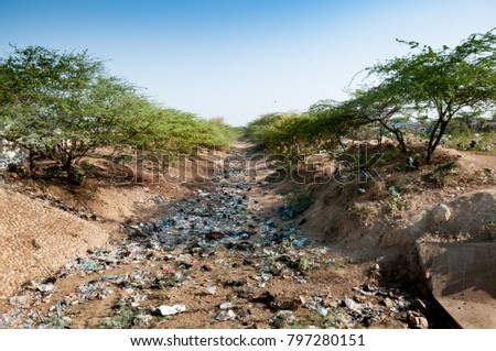 dry river full of plastic garbage Royalty-Free Stock Photo #797280151