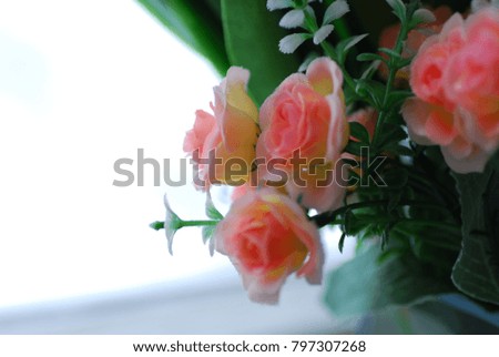 Artificial flowers in the window (color).