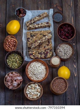 Dried fruits, nuts, seeds on a wooden background