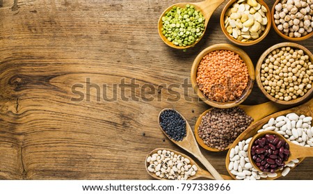 composition of dry legumes of different types, color and flavor on rustic wood background Royalty-Free Stock Photo #797338966
