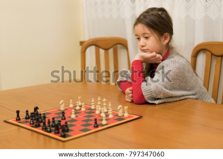Girl playing chess. Intellectual sports