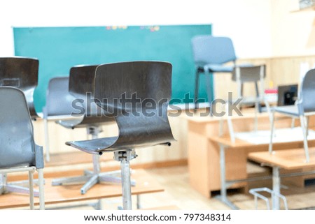 in the classroom, the chairs are on the desks