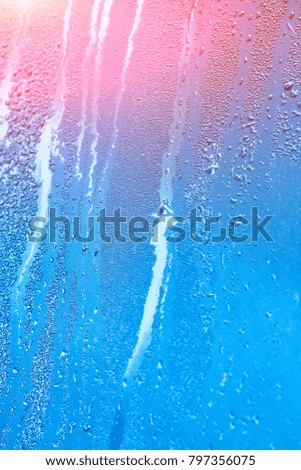 Natural background with condensation on the windows, high humidity. Textures of water droplets of rain flow down the glass