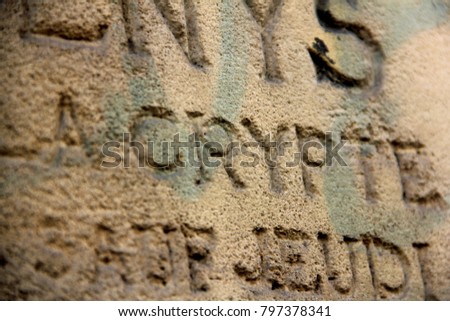 a picture of old words inscribed into a wall Royalty-Free Stock Photo #797378341