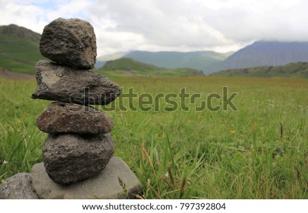 small stone tower in alpine meadows