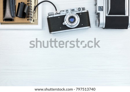 retro cameras, negative films, photo frame and notebook with old pictures, flat view