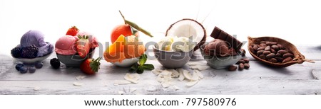 Set of ice cream scoops of different colors and flavours with berries, nuts and fruits 
