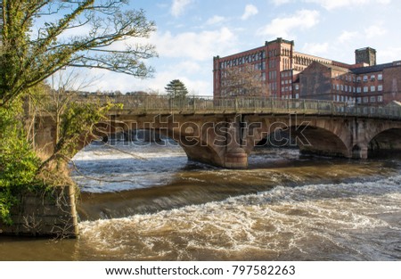 Historic river bridge and mill at Belper, Derbyshire, UK Royalty-Free Stock Photo #797582263