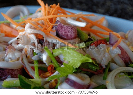 Close up picture of Thai spicy food, Yam Roum Mid Talay. The spicy squid salad.
