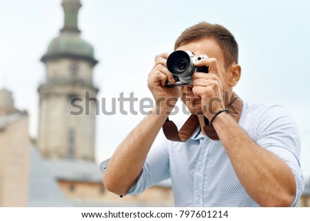 Tourist Man With Camera Taking Photos On Street. Portrait Of Handsome Smiling Male Holding Camera, Making Photo Of Interesting Places While Walking In Old City. Travel Concept. High Quality Image.