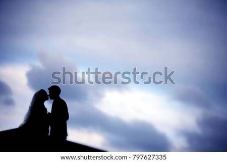 Couple silhouette with blue sky background