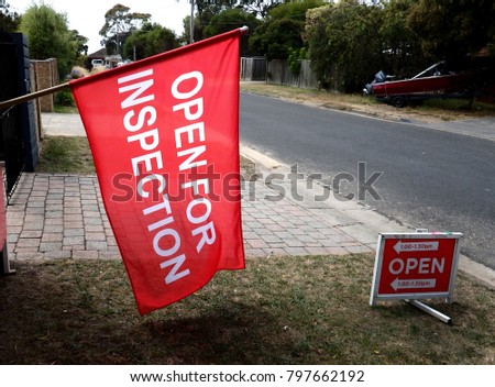 Open for inspection red flag sign in a suburban street