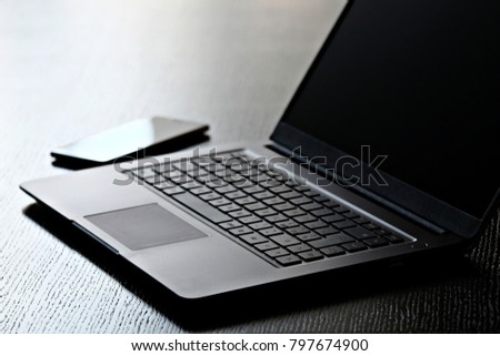 laptop keyboard and smartphone