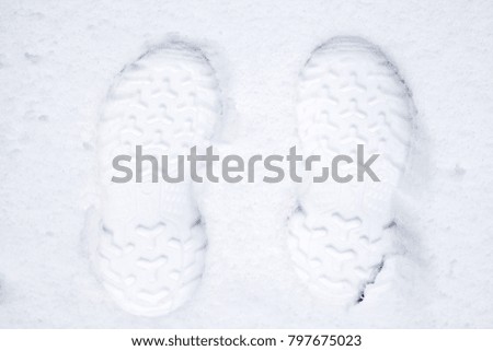 Picture of male footprint in the snow on wintertime