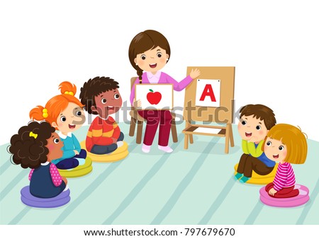 Group of preschool kids and teacher sitting on the floor.Teacher explaining alphabet to children