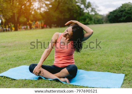 Woman do yoga and relaxation in garden. Woman exercising vital and meditation for fitness lifestyle at the nature background. Concept Yoga