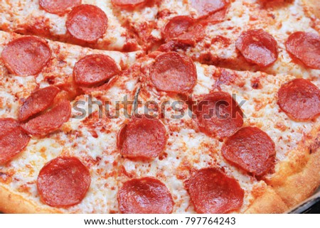 Pepperoni Hot Italian Pizza Close Up Image. Fresh Traditional Recipe Pizza Thin Pie with Pepperoni Sausage, Mozzarella Cheese and Tomato Sauce Toppings. Pizza Isolated on Pizzeria Restaurant Table.