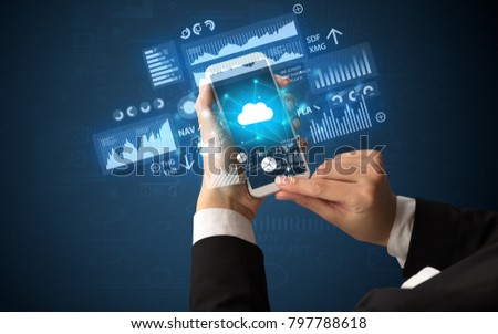 Female hand using smartphone with financial tracking concept illustrated by graphs and symbols Royalty-Free Stock Photo #797788618