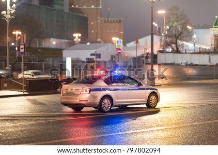 Police car near the kremlin wall at night.