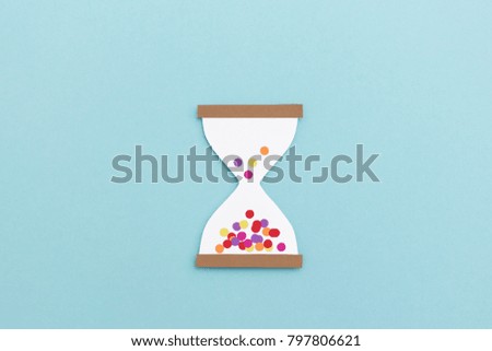Time passes quickly when you're having fun - hour glass with confetti