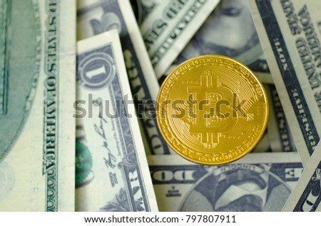 Bit coin with a dollar banknote background.
