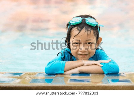 Portrait of asian little girl in swimming pool.