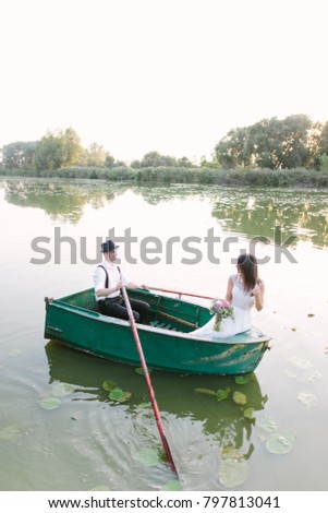 Loving couple floating in a boat on the lake
