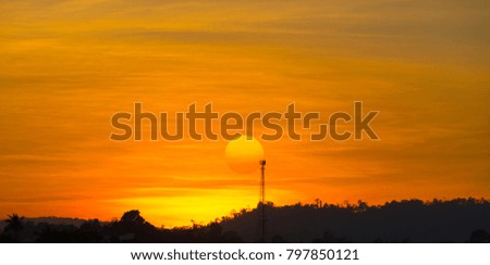 Very beautiful sunset view, forest view with beautiful sunshine, warm lighting.sunset with blur Telecommunication Tower.
