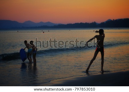 Silhouette of Childrens are playing water at khao takiab beach Hua-Hin Thailand.